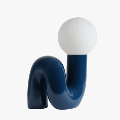Aurelo sculptural table lamp in Midnight Blue with frosted glass globe on hand-curved metal base