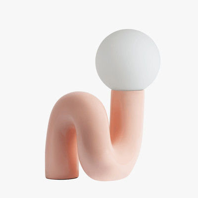 Aurelo sculptural table lamp in Pink with frosted glass globe on hand-curved metal base