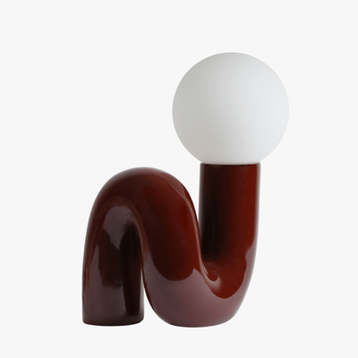 Aurelo sculptural table lamp in Dark Cherry with frosted glass globe on hand-curved metal base