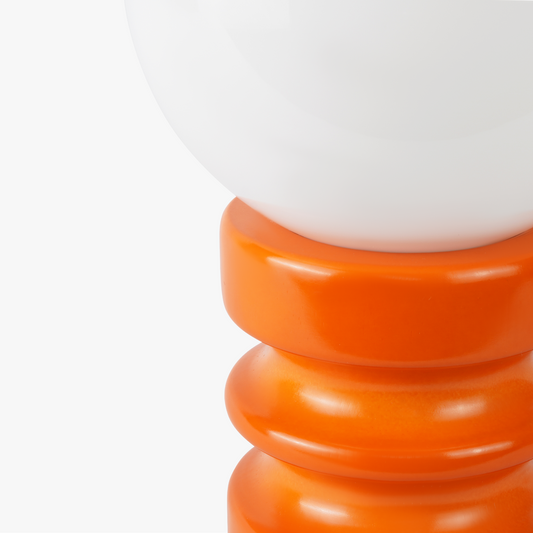 Luma glass table lamp with frosted glass globe shade on a weighted compact base