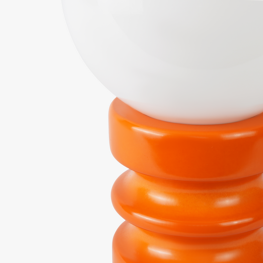 Luma glass table lamp with frosted glass globe shade on a weighted compact base