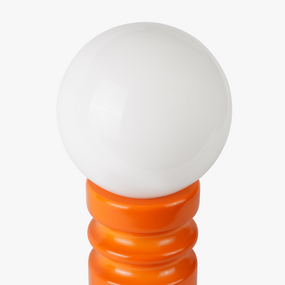 Luma glass table lamp with frosted glass globe shade on a weighted compact base
