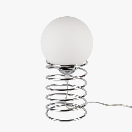 Lyra table lamp with frosted glass globe held by a coiled metal sculptural base