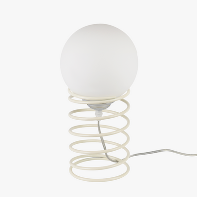 Lyra table lamp with frosted glass globe held by a coiled metal sculptural base