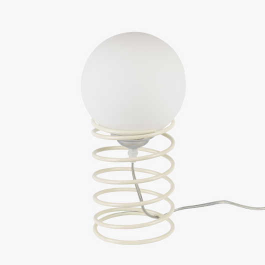 Lyra table lamp with frosted glass globe held by a coiled metal sculptural base