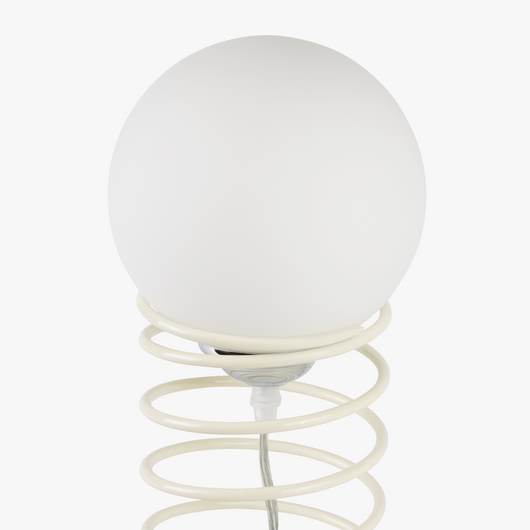 Lyra table lamp with frosted glass globe held by a coiled metal sculptural base